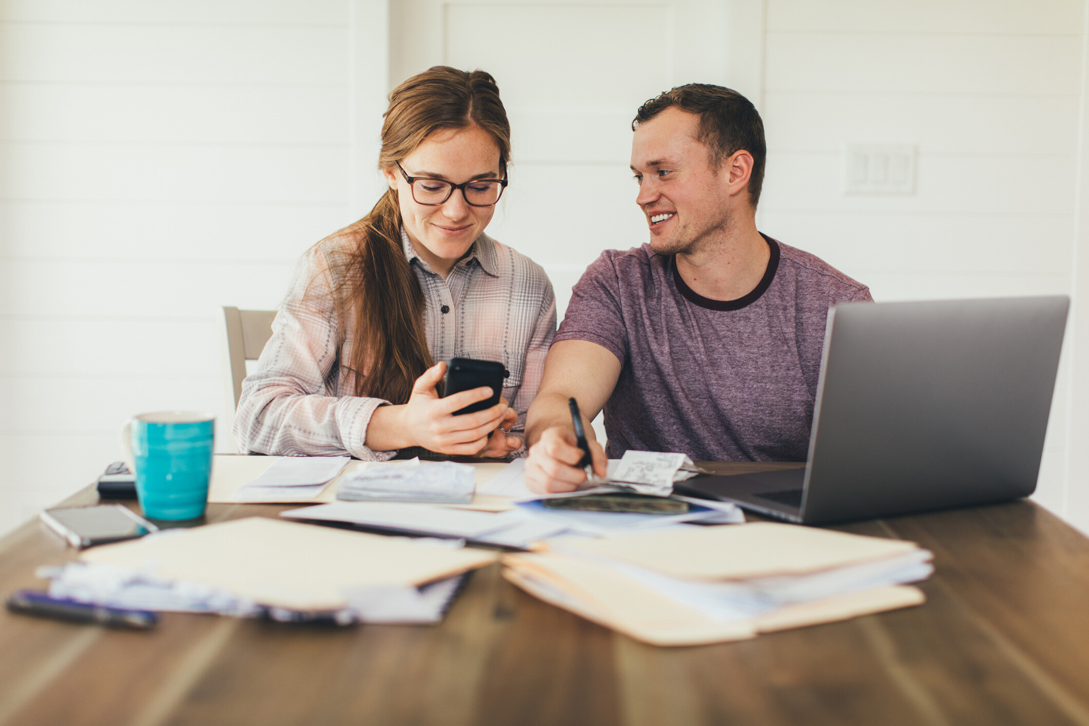 A young couple discussing their mortgage payment in front of their laptop at home.